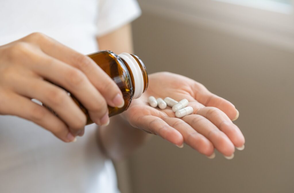 Pills poured out from a bottle into someone's hand