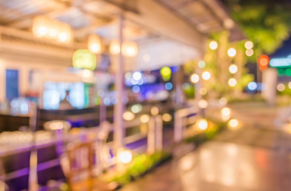 A blurry image of an outdoor restaurant patio and lights.