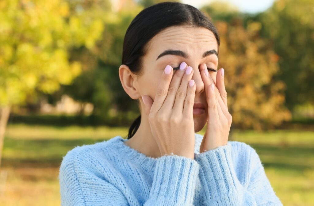 A person rubbing their eyes that are irritated